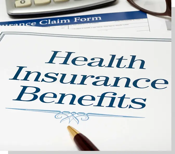 A health insurance benefits form with a pen and calculator.